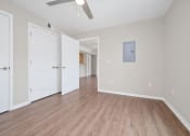 Thumbnail 41 of 64 - a bedroom with hardwood floors and a ceiling fan