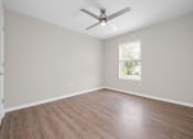 Thumbnail 40 of 64 - an empty room with a ceiling fan and a window