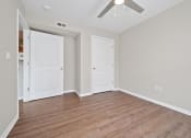 Thumbnail 34 of 64 - a bedroom with two doors and a ceiling fan
