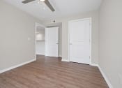 Thumbnail 44 of 64 - a bedroom with a ceiling fan and hardwood floors