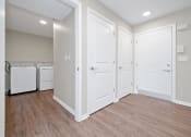 Thumbnail 25 of 64 - a bedroom with two closets and a washer and dryer