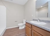 Thumbnail 36 of 64 - a bathroom with a toilet sink and mirror