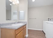 Thumbnail 35 of 64 - a bathroom with a sink and a washer and dryer