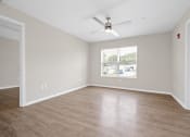 Thumbnail 11 of 64 - an empty room with a ceiling fan and a window