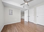 Thumbnail 45 of 64 - a bedroom with two doors and a ceiling fan