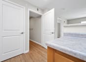 Thumbnail 46 of 64 - a kitchen with white doors and hardwood floors