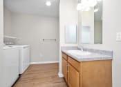 Thumbnail 55 of 64 - a bathroom with a sink and a washer and dryer