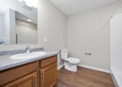 Thumbnail 54 of 64 - a bathroom with a toilet sink mirror and bathtub