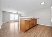 Thumbnail 16 of 64 - a kitchen and living room with hardwood floors and a large window