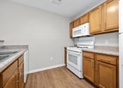 Thumbnail 12 of 64 - a kitchen with wood cabinets and white appliances
