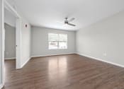 Thumbnail 18 of 64 - a bedroom with hardwood floors and a ceiling fan