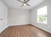 Thumbnail 19 of 64 - an empty room with a ceiling fan and a window