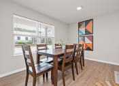 Thumbnail 50 of 64 - a dining room with a wooden table and chairs and a large window
