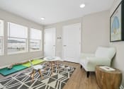 Thumbnail 48 of 64 - a living area with a couch coffee table and three windows