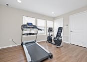 Thumbnail 57 of 64 - a home gym with a treadmill and exercise balls