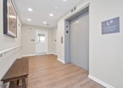 Thumbnail 63 of 64 - a long hallway with a bench and a door