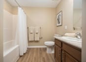 Thumbnail 58 of 58 - A bathroom with a toilet, sink, and bathtub.