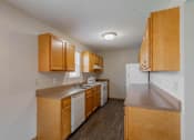 Thumbnail 34 of 59 - A kitchen with wooden cabinets and appliances.