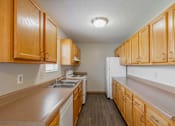 Thumbnail 45 of 59 - A kitchen with wooden cabinets and a white refrigerator.