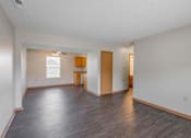 Thumbnail 46 of 59 - A large empty room with wooden floors and white walls.