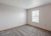 Thumbnail 40 of 59 - A room with a carpeted floor and a window.