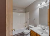Thumbnail 47 of 59 - A bathroom with a white toilet, a white sink, and a white bathtub.