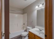 Thumbnail 41 of 59 - A bathroom with a toilet, sink, and bathtub.