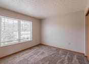 Thumbnail 50 of 59 - A room with a carpeted floor and a window with blinds.
