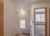 Thumbnail 58 of 59 - A room with a staircase leading to the second floor.