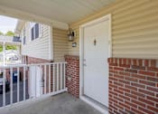Thumbnail 51 of 59 - A white door with a gold handle is on a brick wall.
