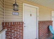 Thumbnail 52 of 59 - A white door with a black lantern above it and a number 650b on the wall.