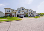 Thumbnail 49 of 59 - A row of houses with cars parked in front.