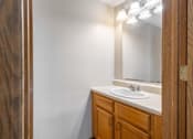 Thumbnail 37 of 59 - A bathroom with a sink and a mirror.