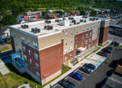 Thumbnail 1 of 36 - a large brick building with a white roof