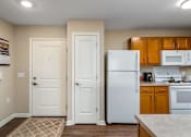 Thumbnail 16 of 41 - a kitchen with a white refrigerator freezer next to a stove top oven