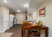 Thumbnail 26 of 41 - a kitchen and dining room with a wooden table and chairs