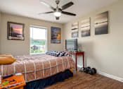 Thumbnail 21 of 41 - a bedroom with a bed and a tv