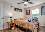 Thumbnail 23 of 41 - a bedroom with a bed and a ceiling fan