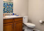 Thumbnail 19 of 41 - a bathroom with a toilet sink and mirror