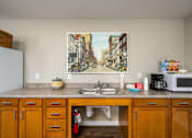 Thumbnail 31 of 41 - a kitchen with a sink and a microwave