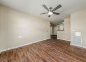 Thumbnail 9 of 36 - a living room with hardwood floors and a ceiling fan