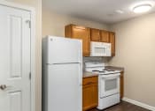 Thumbnail 11 of 36 - our apartments have a small kitchen with a white stove and refrigerator