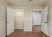 Thumbnail 17 of 36 - a bedroom with two doors and a closet