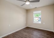 Thumbnail 14 of 36 - a bedroom with a ceiling fan and a window