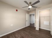 Thumbnail 13 of 36 - a bedroom with a ceiling fan and a closet
