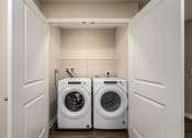 Thumbnail 12 of 36 - a washer and dryer in a laundry room