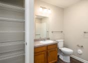Thumbnail 22 of 36 - a bathroom with a toilet sink and mirror