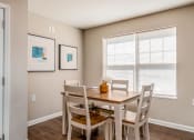 Thumbnail 25 of 36 - a dining room with a table and chairs