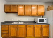 Thumbnail 30 of 36 - a kitchen with a sink a microwave and a refrigerator