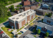 Thumbnail 11 of 41 - an aerial view of a large brick building with a flat roof